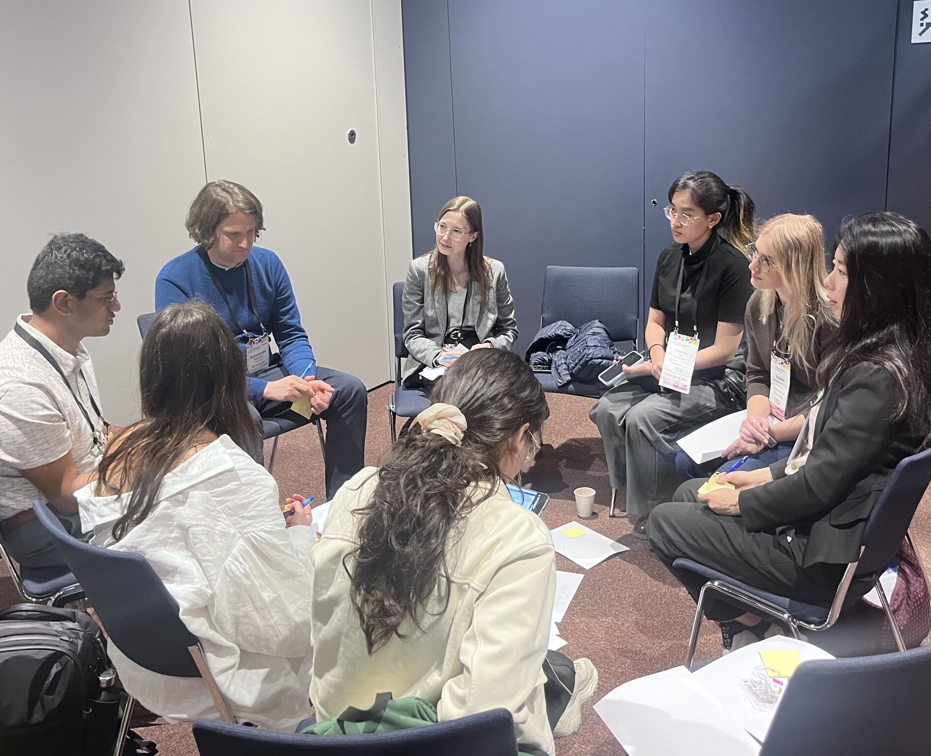 Workshop participants sit in a circle for discussion.