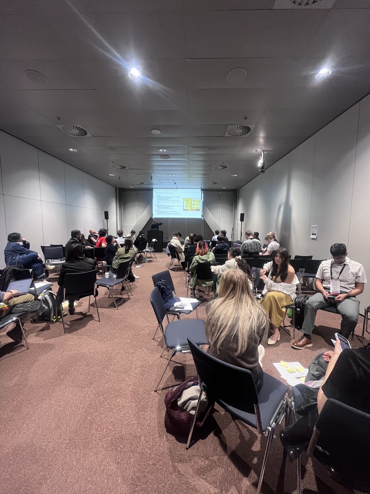 Small groups work together in a conference workshop room.