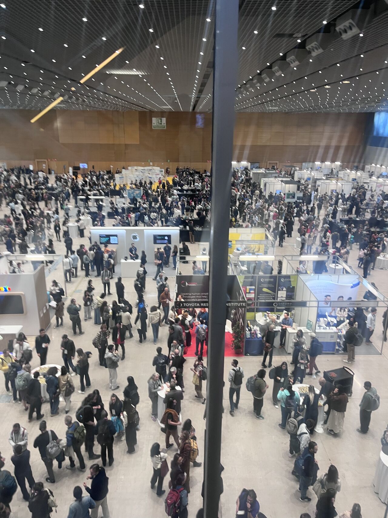 An overhead view of a crowded conference exhibition hall.