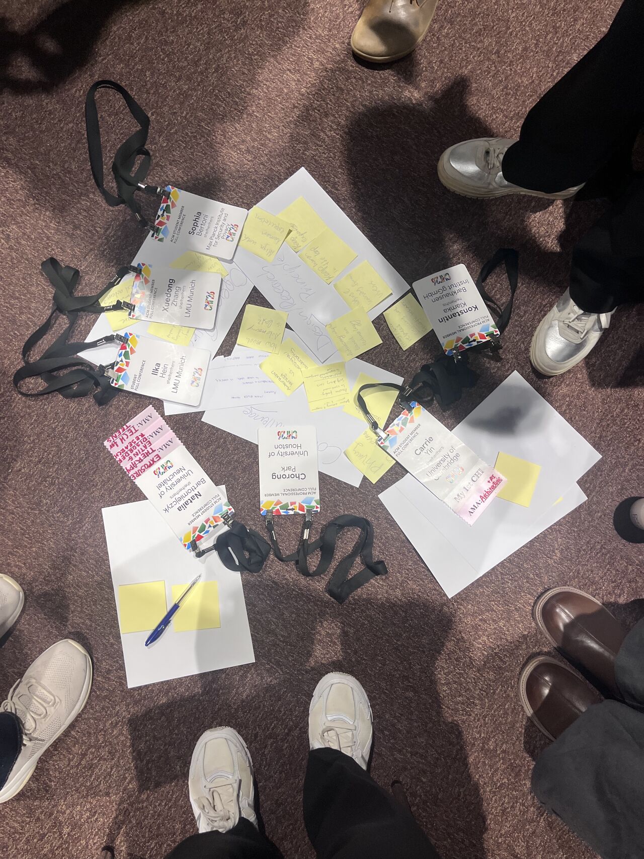 Workshop notes and sticky notes are arranged on the floor among chairs.