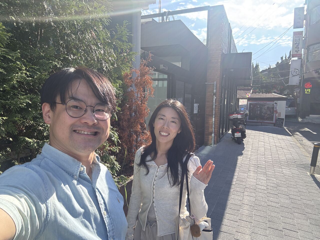 Two visitors smile for an outdoor photograph.