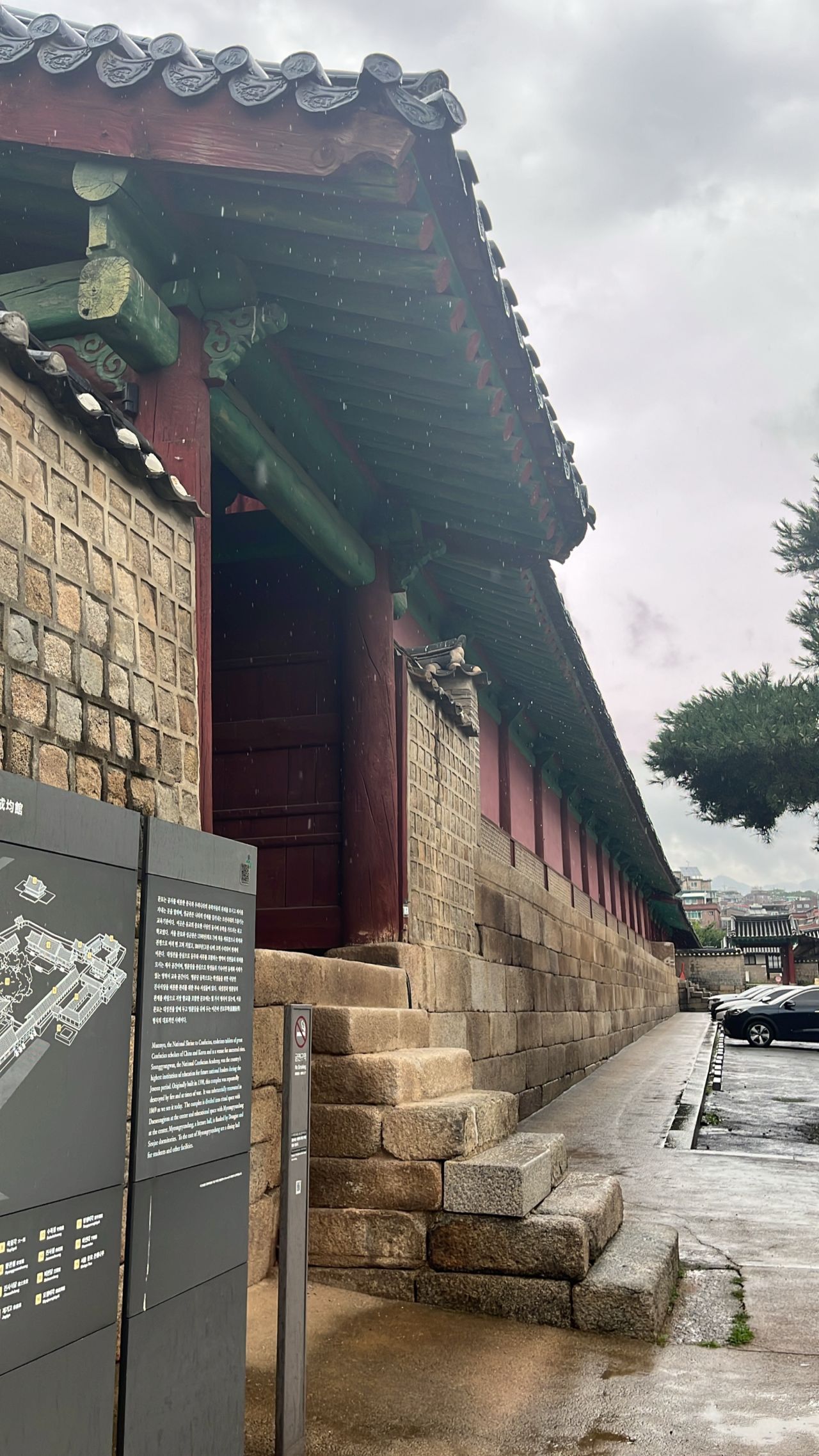 A traditional building with painted wooden eaves and stone steps.