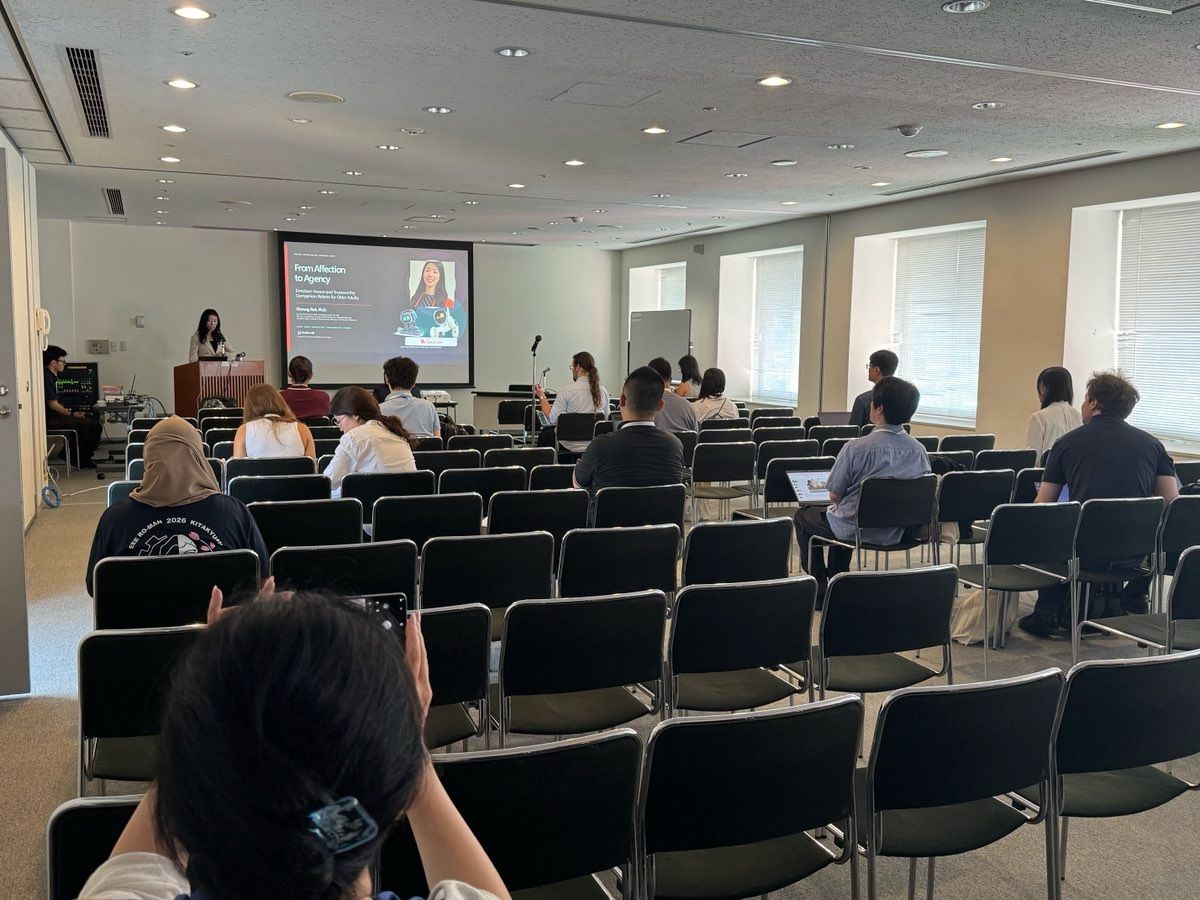 A wide view of the workshop audience and presentation screen.