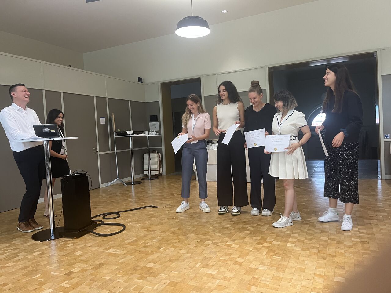 Participants receive recognition at the front of the event room.